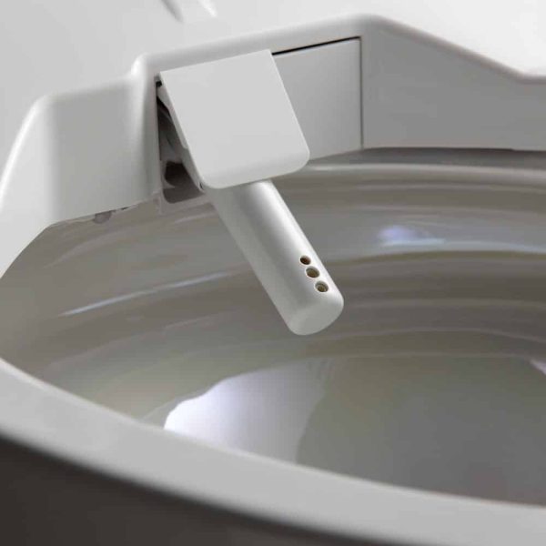 Eine Nahaufnahme einer weißen Toilette mit einem Knopf darauf, ideal für ein modernes Badezimmerrenovierungsprojekt. | casaceramica