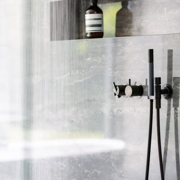 Duscharmatur von Vola in Schwarz mit Aesop Seife in der Nische